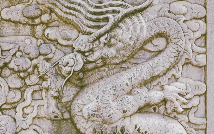 Stone carving of a Chinese dragon with clouds
