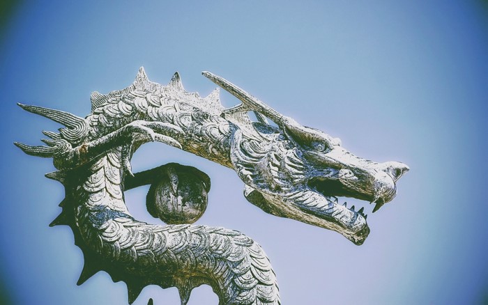 Stone Dragon Statue Against Blue Sky