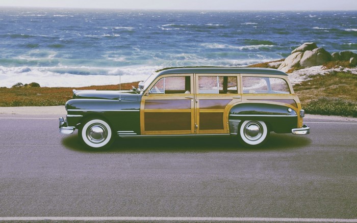 Vintage woody station wagon parked by the ocean