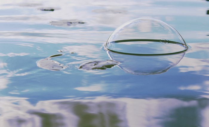 Bubble floating on water with reflections