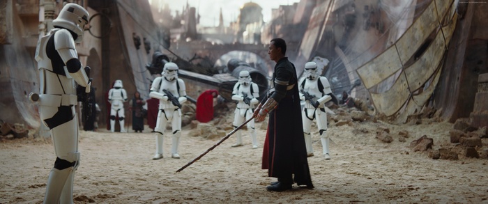 Stormtroopers and a man with a staff in Rogue One