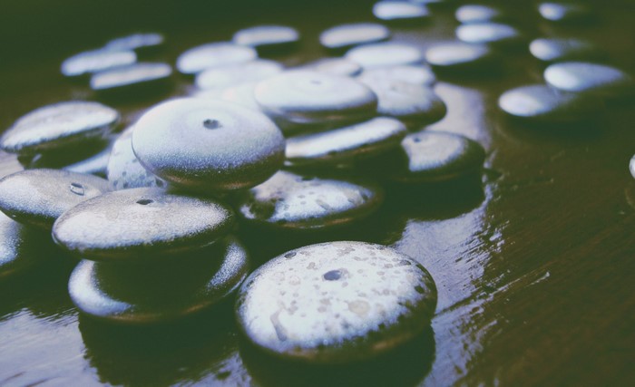 Close up of smooth, round stones with holes