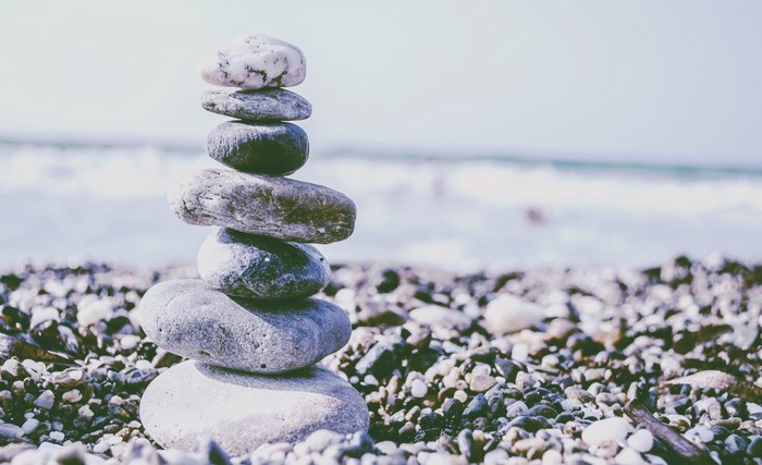 Stack of stones on a beach with ocean waves
