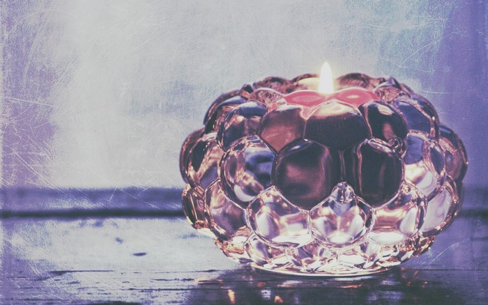 Candle in a decorative glass holder