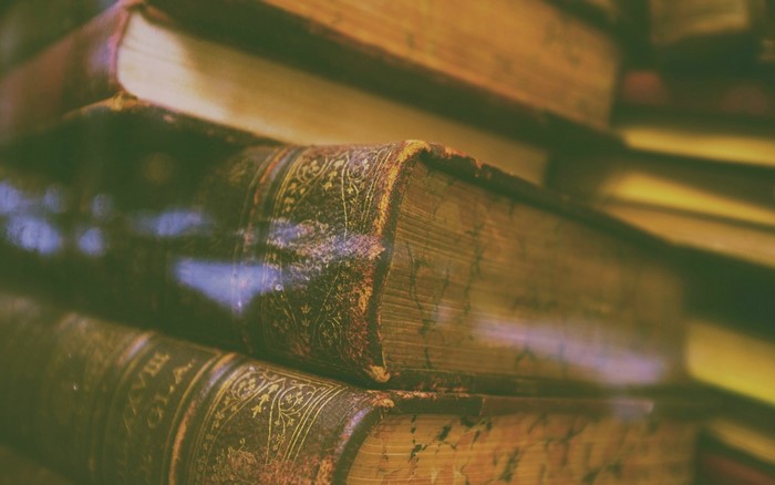 Stack of old vintage books with ornate covers