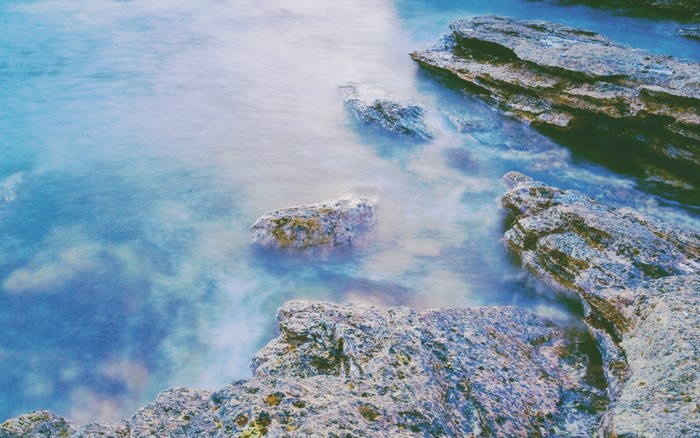 Rocks in the ocean with long exposure water