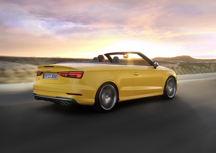 Yellow Audi S3 Cabriolet driving on a road at sunset