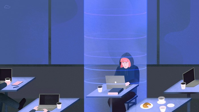 Person working on laptop in a blue digital space