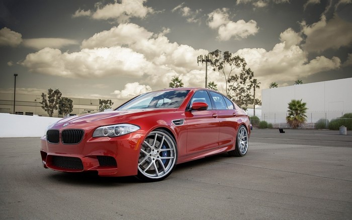 Red BMW M5 Sedan with custom wheels
