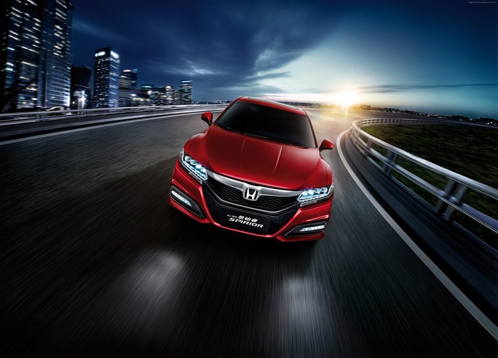 Red Honda Spirior Si driving on a highway at night