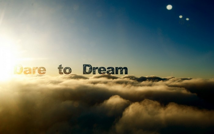 Dare to Dream quote over clouds at sunrise
