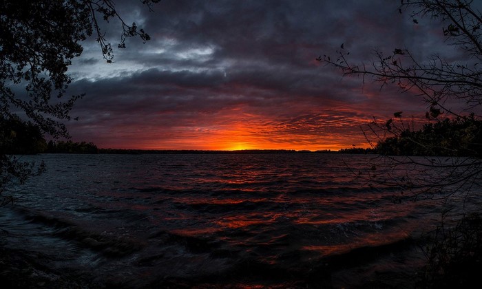 Sunset over the ocean with dramatic clouds