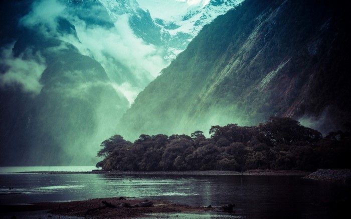 Misty Fjord with Snow-Capped Mountains and Forested Shoreline