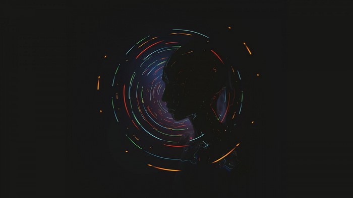 Silhouette of a head with colorful orbiting lights