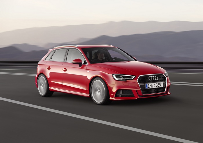 Red Audi A3 Sportback driving on a road