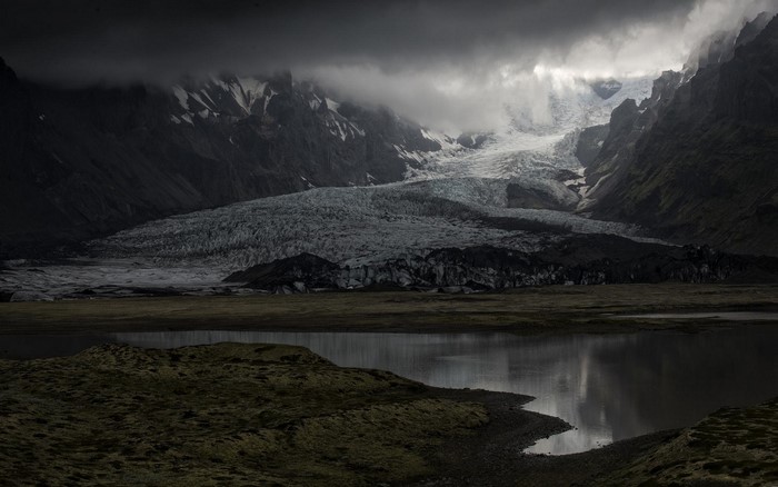 Glacier and lake in Iceland under cloudy skies