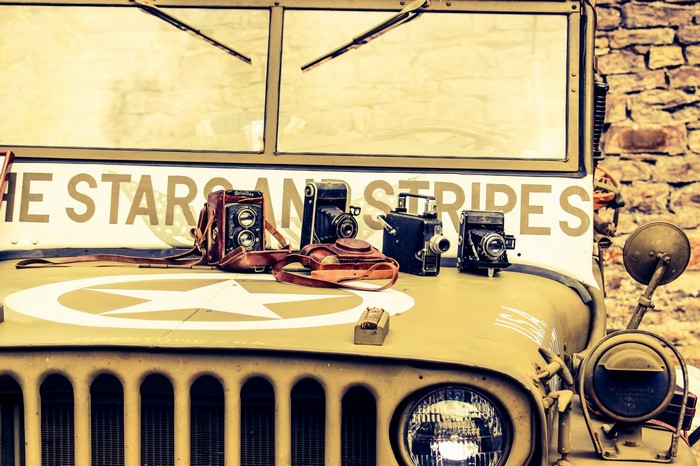 Vintage Jeep with antique cameras and "The Star and Stripes" text