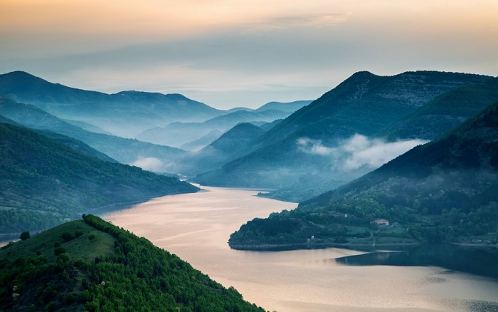 Misty mountains and a lake at dawn