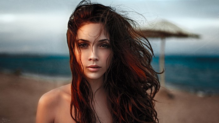 Woman with windblown hair on a beach