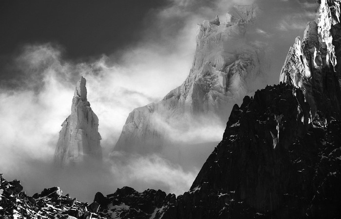 Monochrome mountains shrouded in mist and clouds