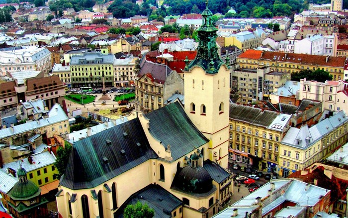 Aerial view of a European city with a prominent church tower