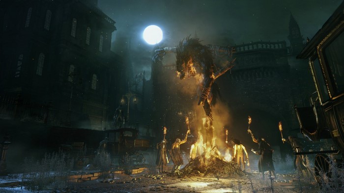 Bloodborne screenshot of a fiery creature and people with torches