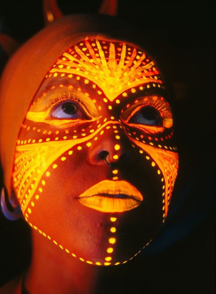 Woman with glowing face paint and headgear