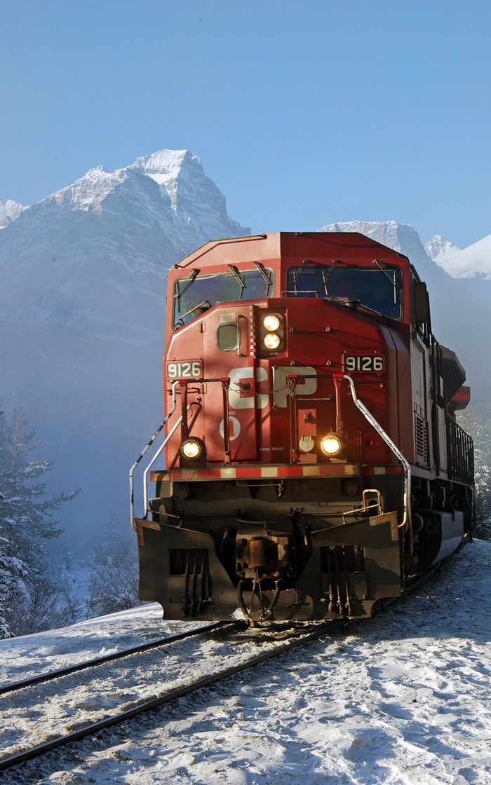 Red CP 9126 locomotive in snowy mountains