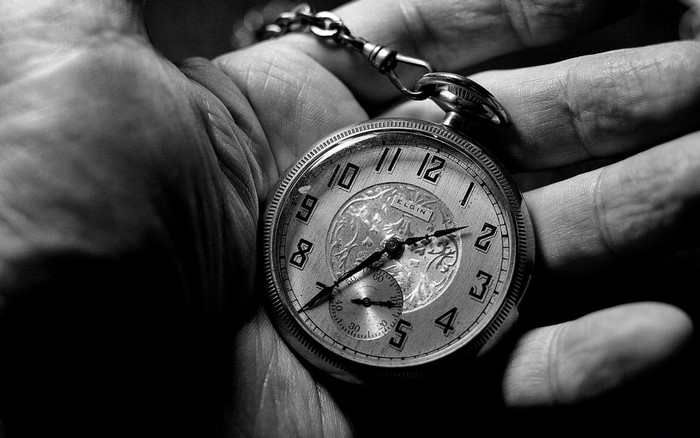 Close up of a vintage Elgin pocket watch in hand