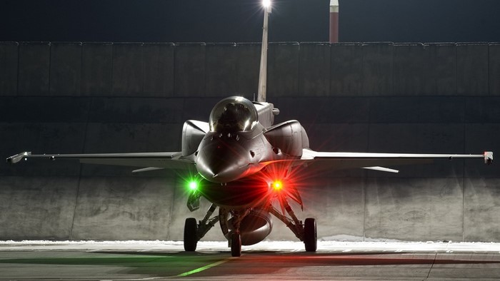 F-16 Fighting Falcon aircraft on tarmac at night