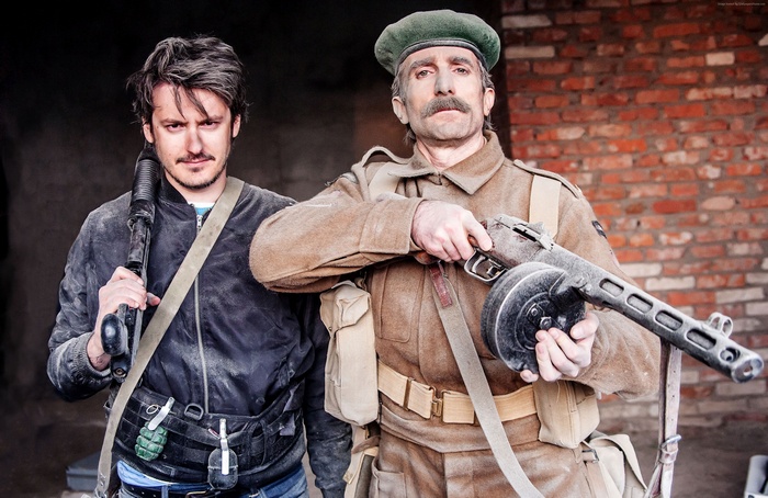 Two men with guns, one in military uniform