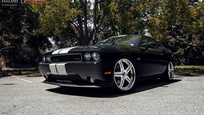 Black Dodge Challenger SRT with white stripes and custom rims