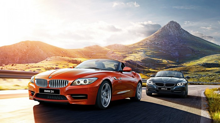Two BMW Z4 convertibles driving on a mountain road