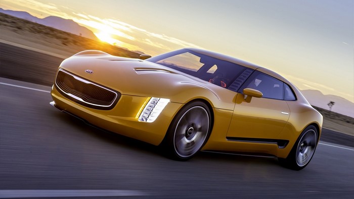 Yellow Kia GT4 Stinger Concept sports car driving on a road