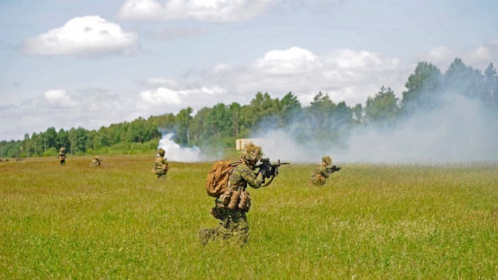 Soldiers in a field with smoke