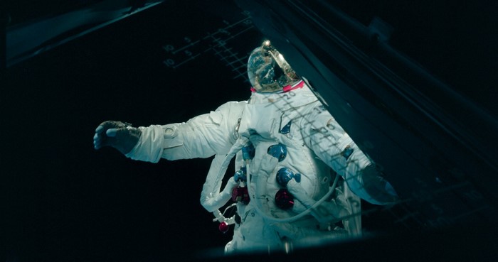 Astronaut in a white spacesuit with blue and red accents