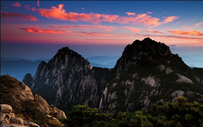 Mountain range at sunset with colorful clouds