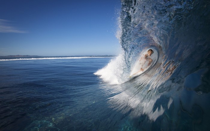 Surfer riding a wave barrel