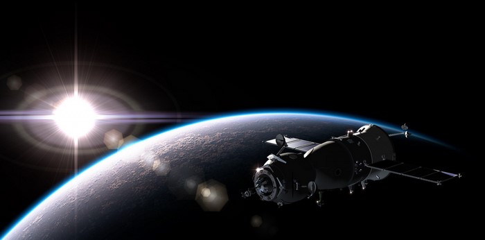 Spacecraft orbiting Earth with sun flare