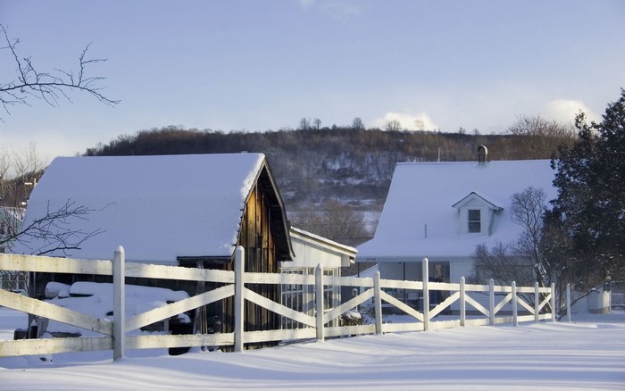 Snowy landscape with houses and fence