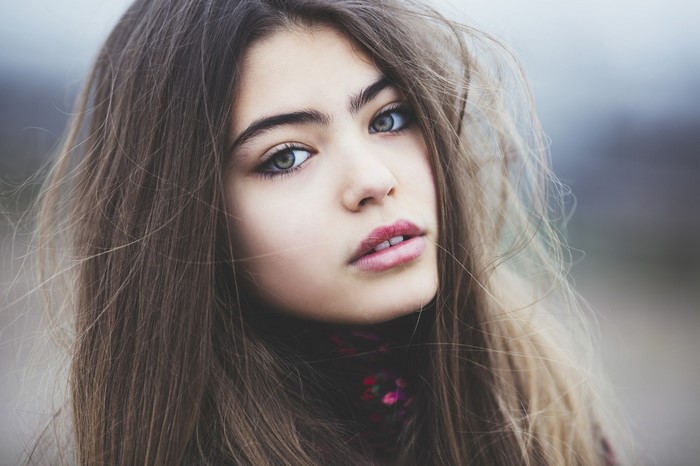 Close-Up Portrait of Young Woman with Long Hair