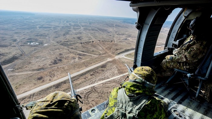 Canadian soldiers in a helicopter over Poland