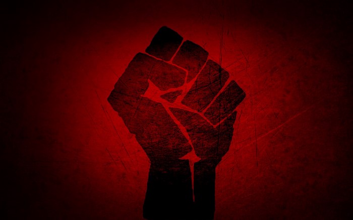 Silhouette of a raised fist on a red background