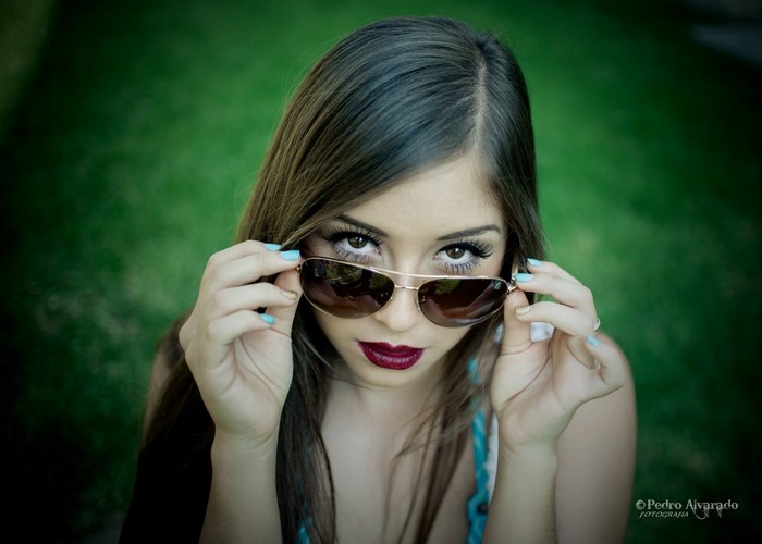 Woman wearing sunglasses and dark lipstick
