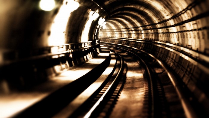 Subway tunnel with train tracks and lights