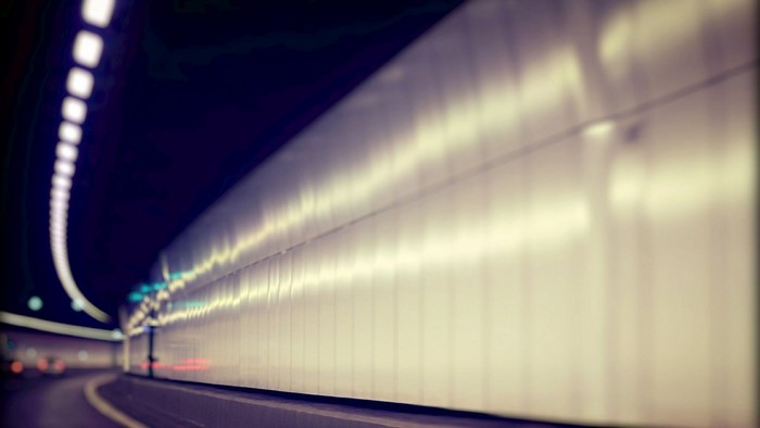 Interior of a brightly lit tunnel at night