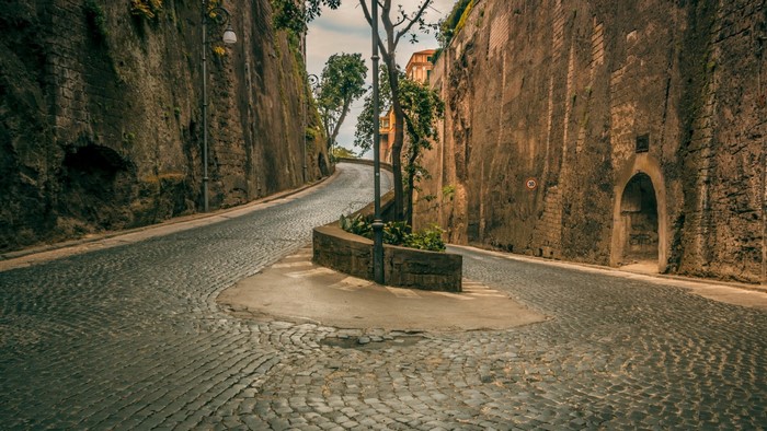Cobblestone street in Sorrento, Italy with high walls