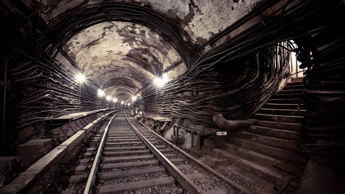 Subway tunnel with railway tracks and cables