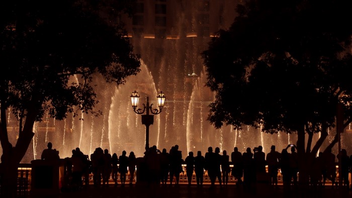 Crowd watching illuminated fountains at night