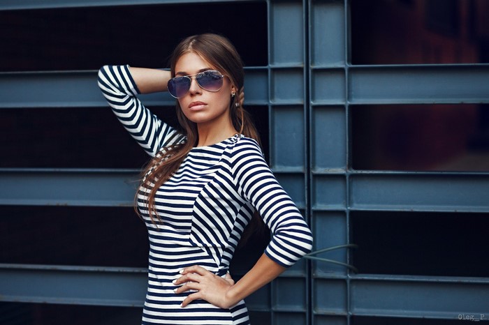 Woman wearing striped dress and sunglasses